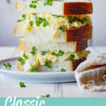 Egg mayo and cress sandwich stacked on a plate. A text overlay says 'classic egg mayo'