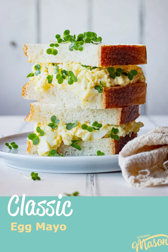 Egg mayo and cress sandwich stacked on a plate. A text overlay says 'classic egg mayo'