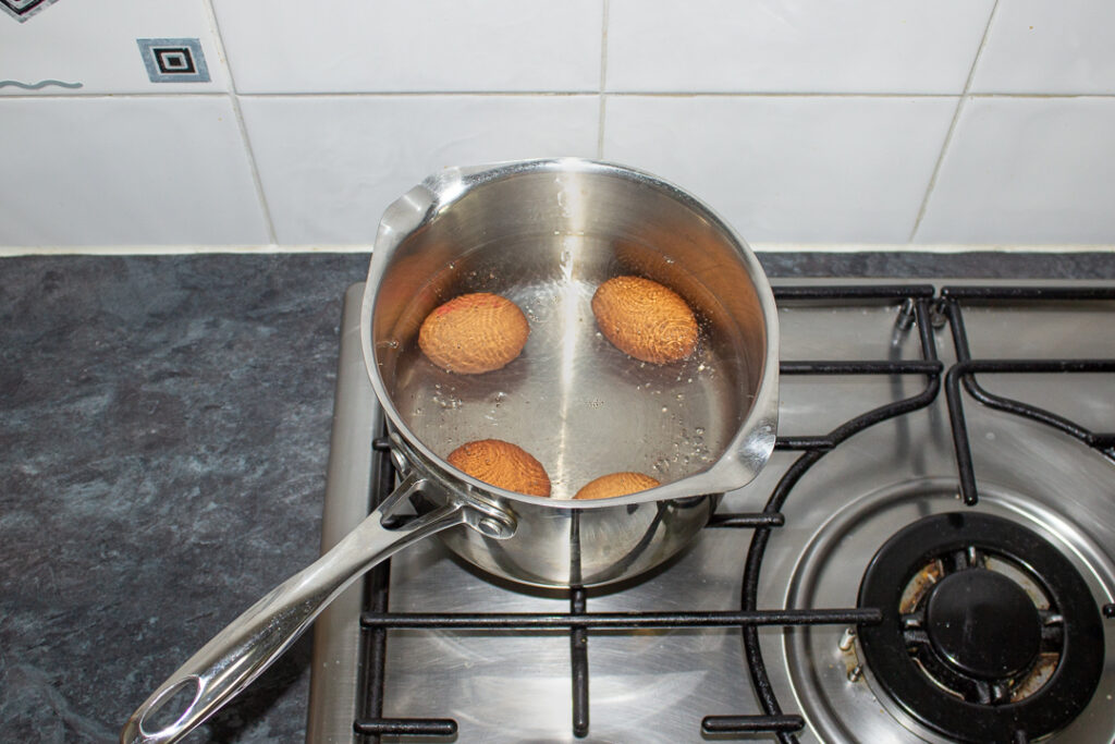 4 eggs in a pan of boiling water on the stove