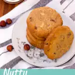 Nutty cookies on a plate with a glass of milk to the side. A text overlay says 'Nutty Cookies'