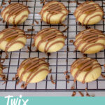 Twix thumbprint cookies on a wire rack set over paper