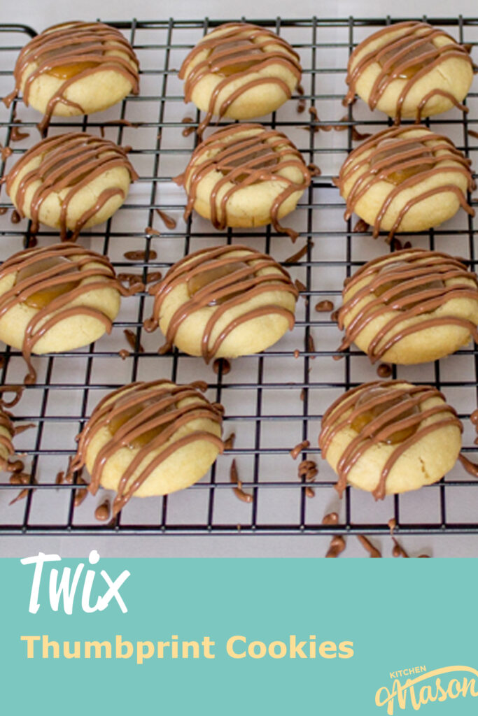 Twix thumbprint cookies on a wire rack set over paper