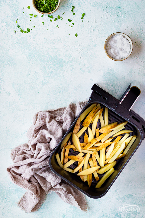 Cut soaked and dried fries in an air fryer basket