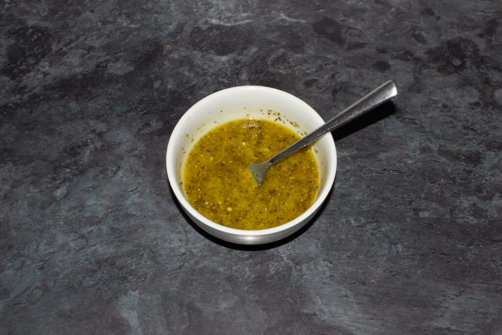 Italian salad dressing in a bowl with a fork