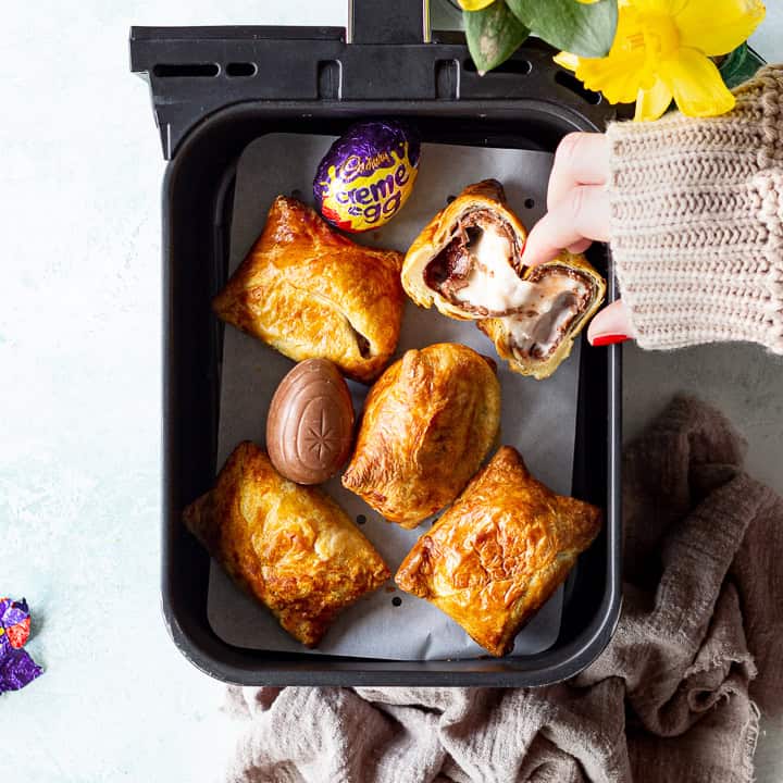 Someone taking an air fried Creme Egg croissant from an air fryer drawer