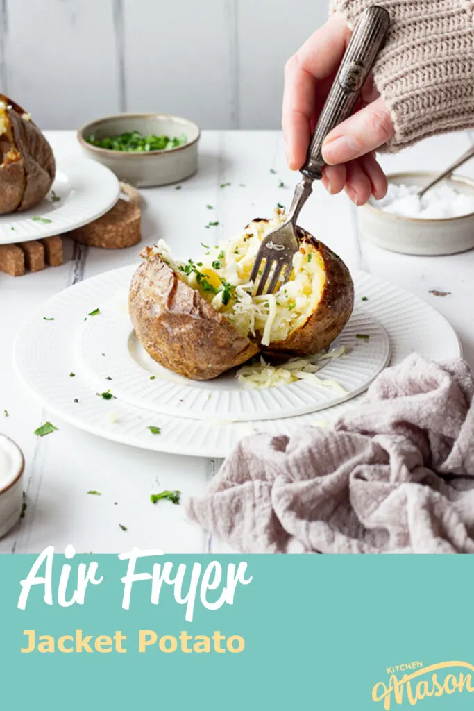 Someone forking a Ninja air fryer jacket potato with cheese. A text overlay says 'Air Fryer Jacket Potato'.
