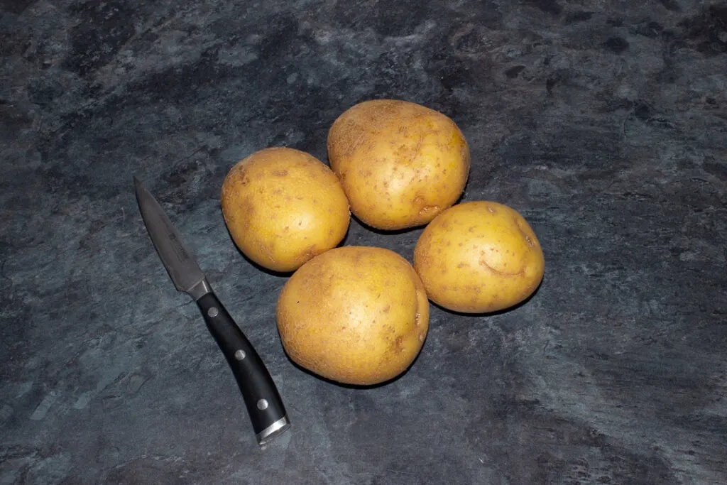 4 potatoes pierced with a knife