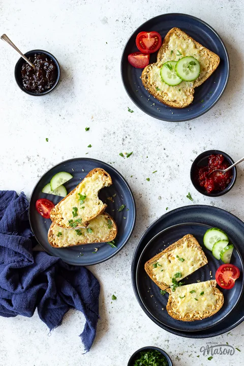 3 plates of air fryer cheese on toast with tomato and cucumber slices