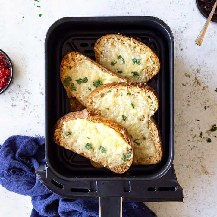 4 slices of cheese on toast in an air fryer drawer