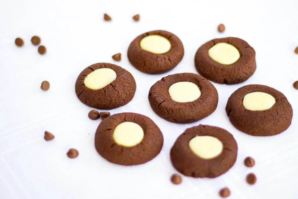 Mint chocolate thumbprint cookies on a white tablecloth