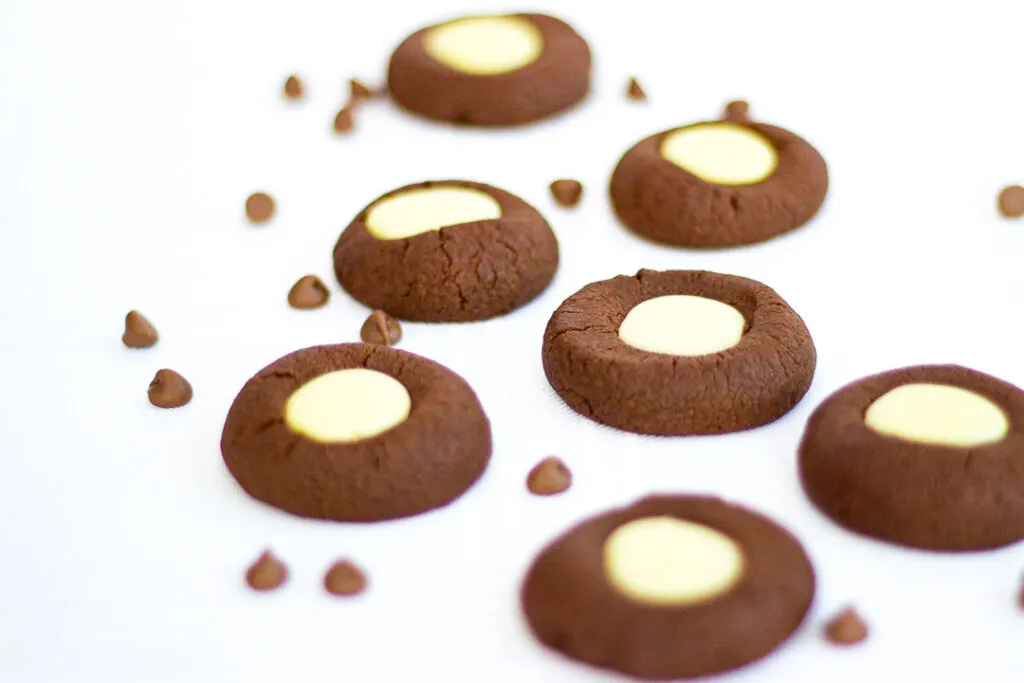 Several mint chocolate thumbprint cookies on a worktop
