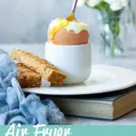 Air fryer boiled egg with a spoon in it. A text overlay says 'air fryer boiled eggs'