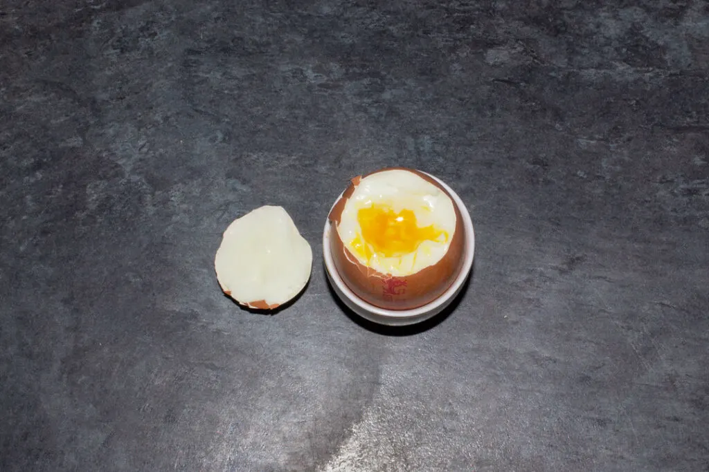 An air fryer soft boiled egg in an egg cup