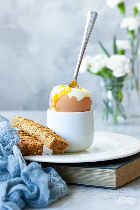 A spoon in an air fried soft boiled egg