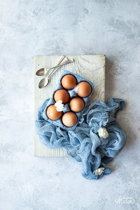 Eggs and spoons on a chopping board