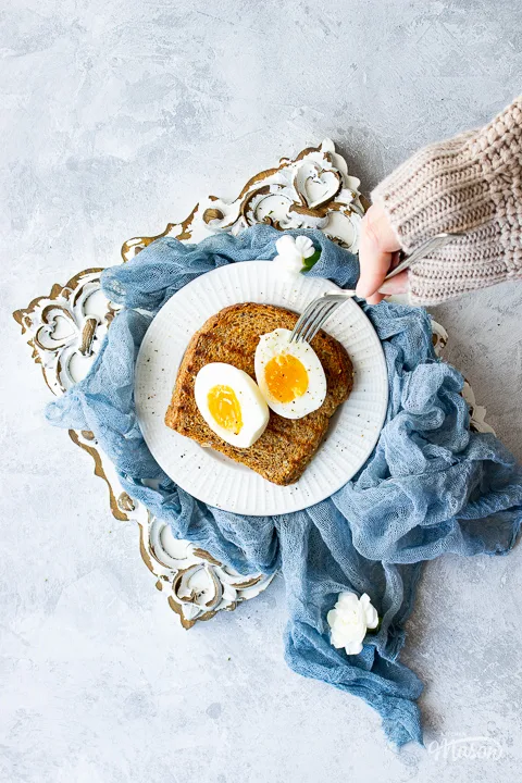 Air fryer eggs on toast on a white plate