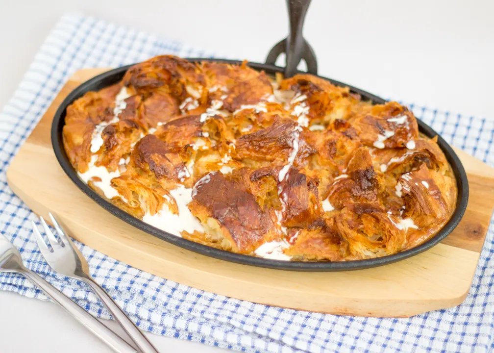 Caramel croissant pudding in a cast iron pan