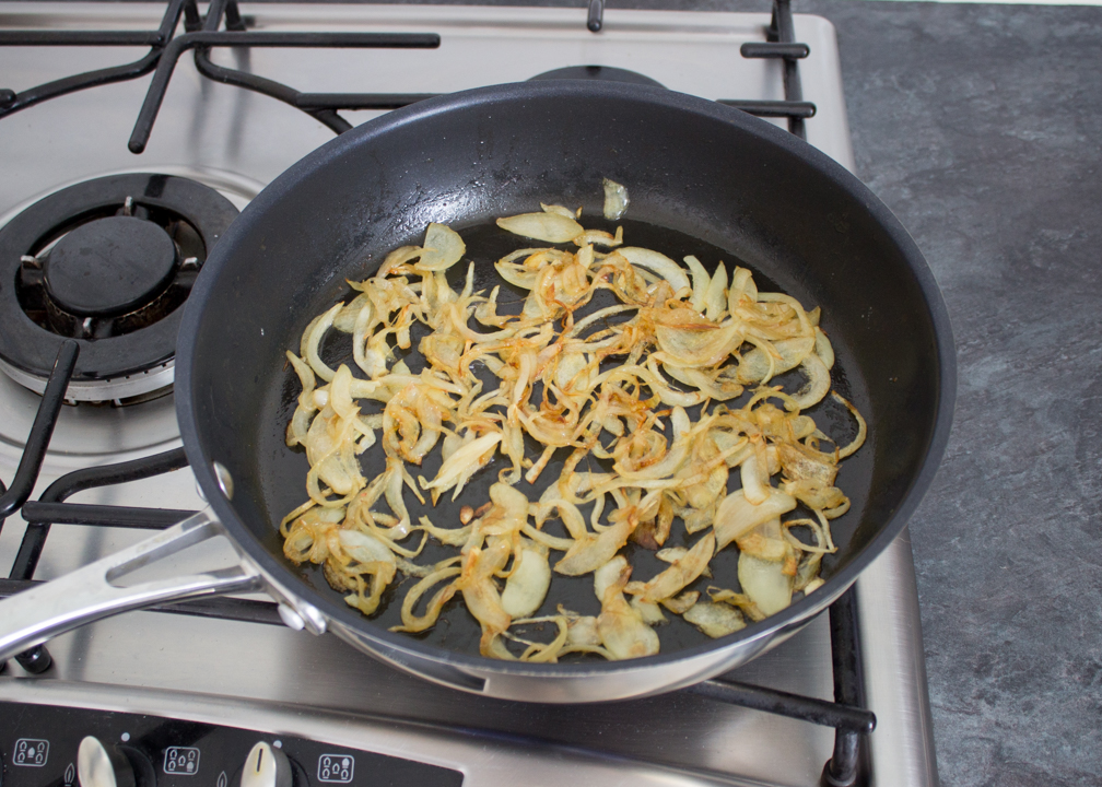Caramelised onions in a large frying pan