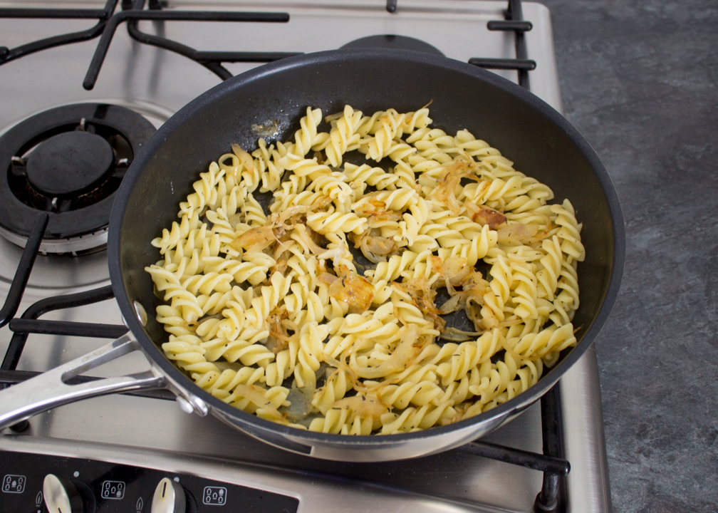 Onion pasta in a frying pan