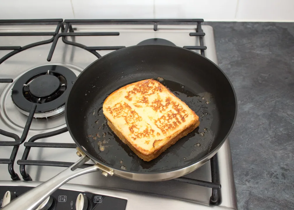Golden and cooked savoury French toast in a frying pan