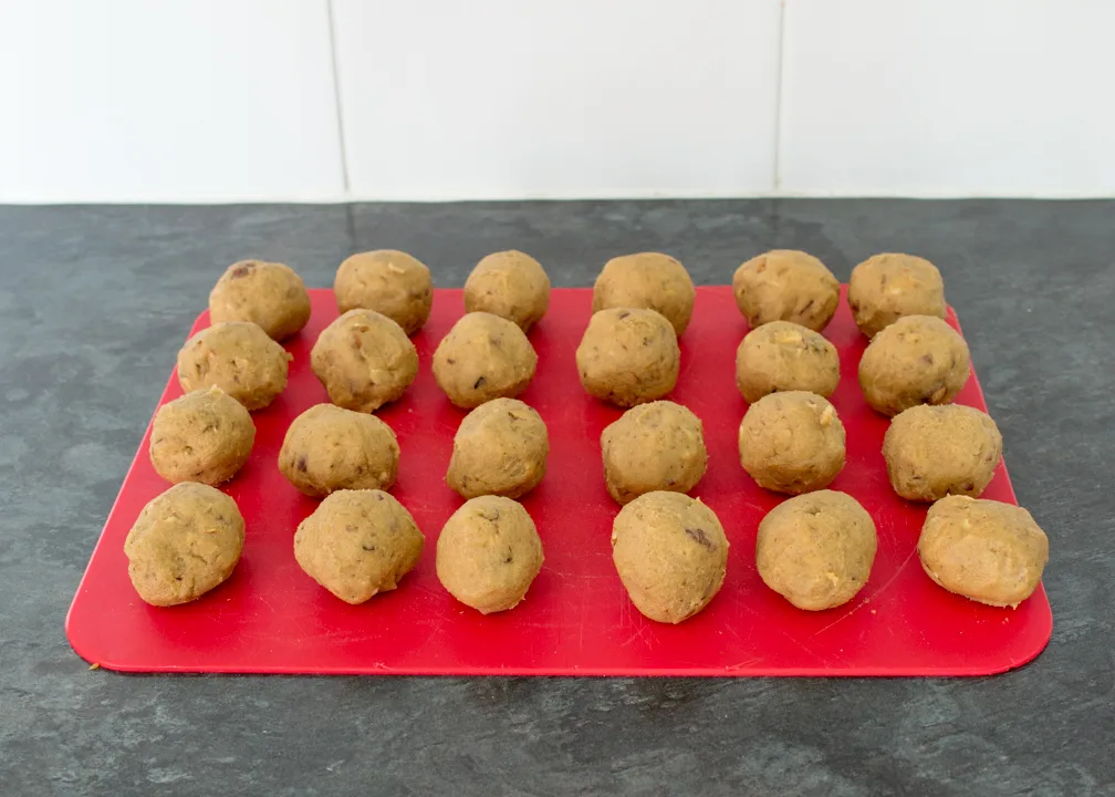 Cookie dough balls on a chopping board