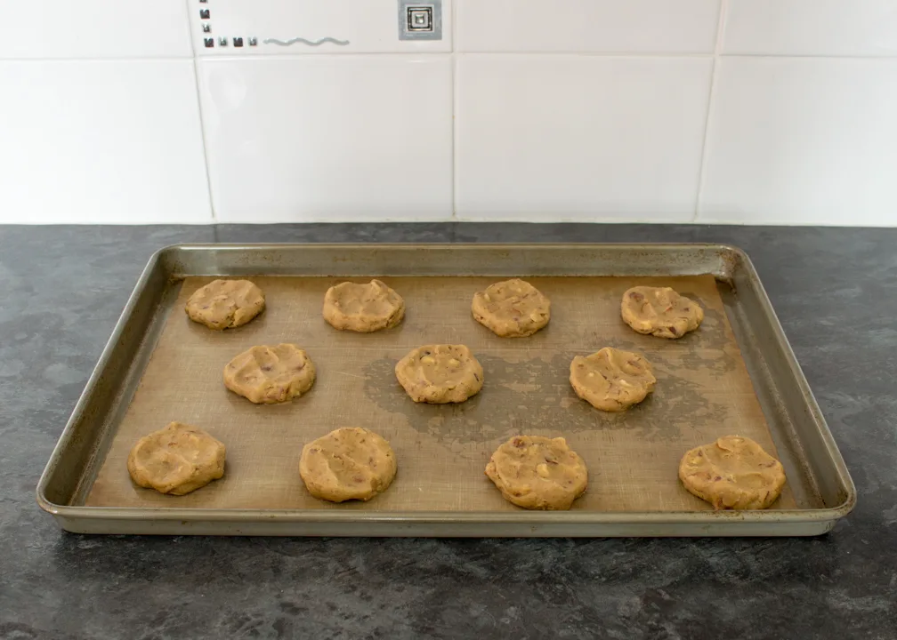 Unbaked cookies on a lined baking tray
