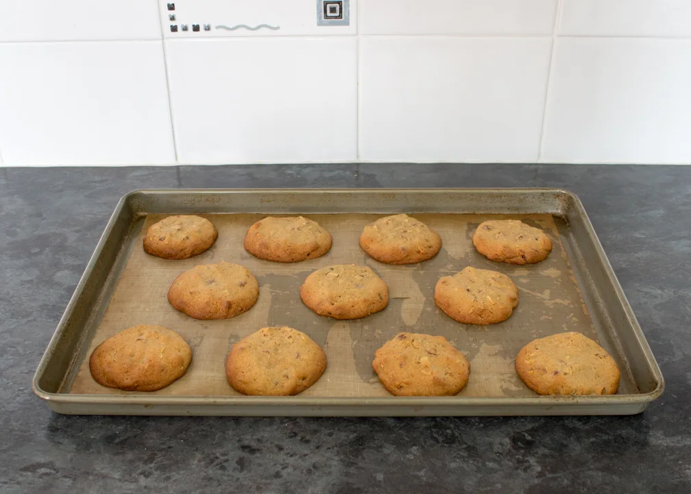 Baked cookies on a lined baking tray