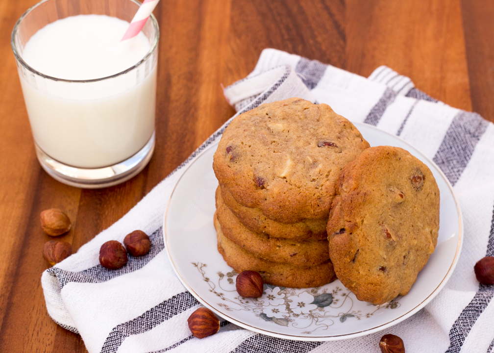 Nutty cookies on a plate with a glass of milk to the side