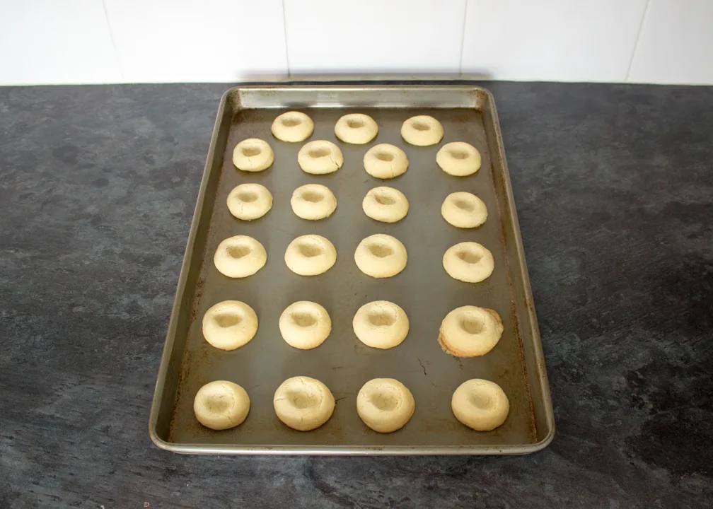 Baked thumbprint cookies on a tray