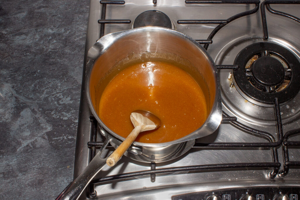 Melted sugar, golden syrup and butter in a saucepan on the hob