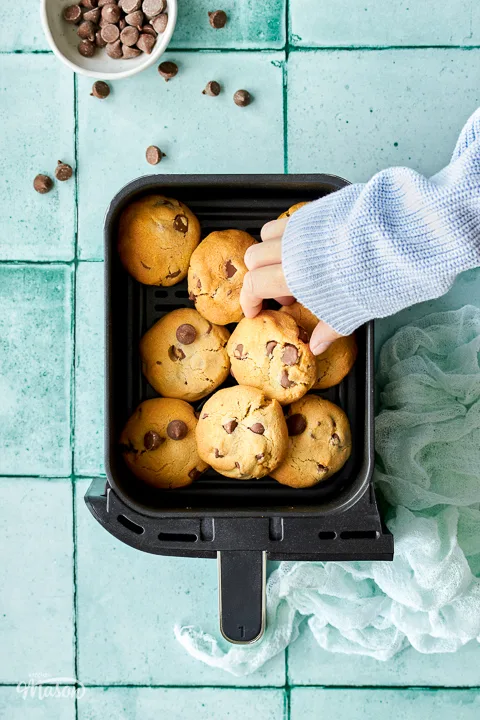 Cooked air fryer chocolate chip cookies in an air fryer drawer