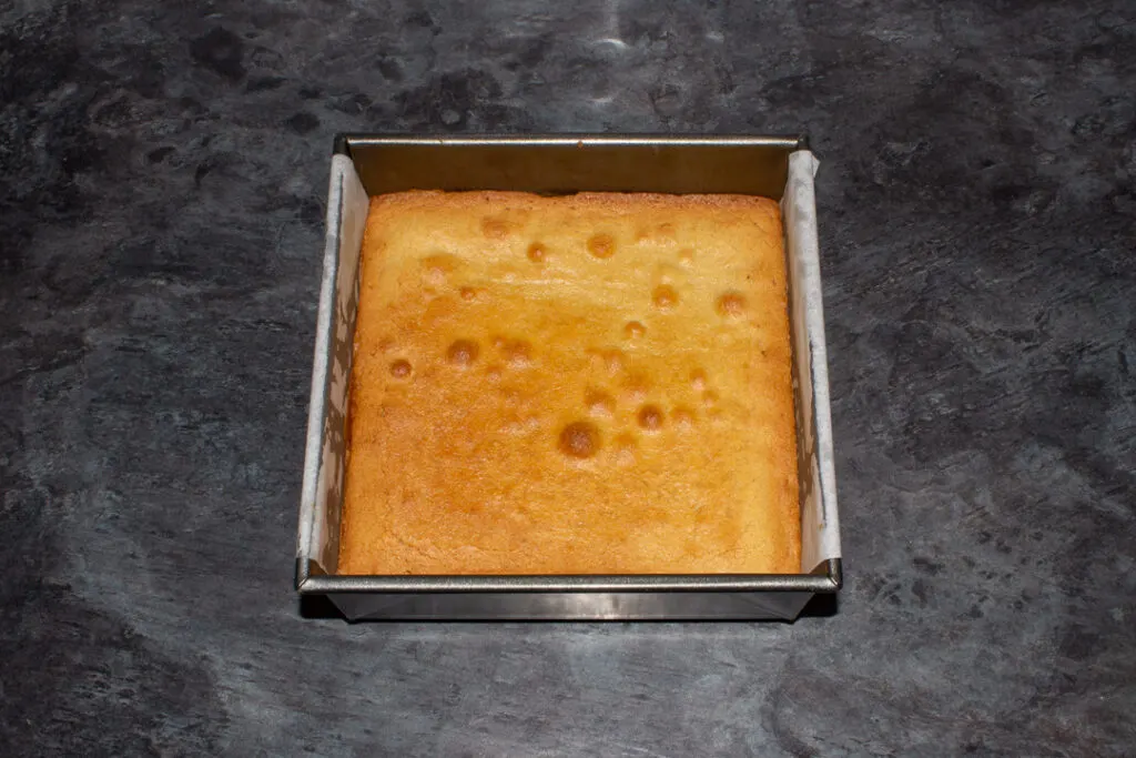 Baked blondie cooling in a baking tin