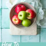 A bowl of apples on a white board. A text overlay says "how to cut an apple"