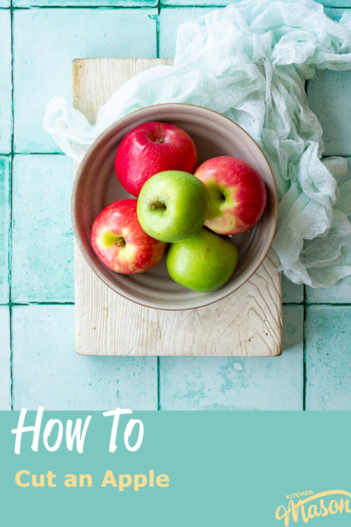 A bowl of apples on a white board. A text overlay says "how to cut an apple"