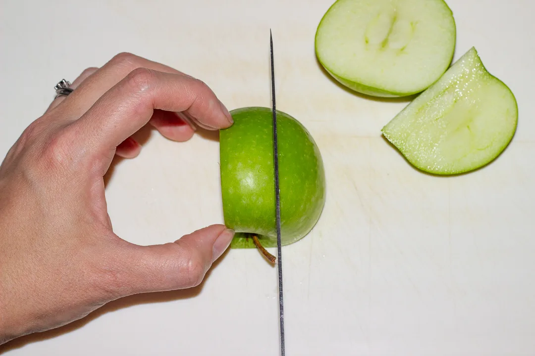 An apple being prepared for thin slicing