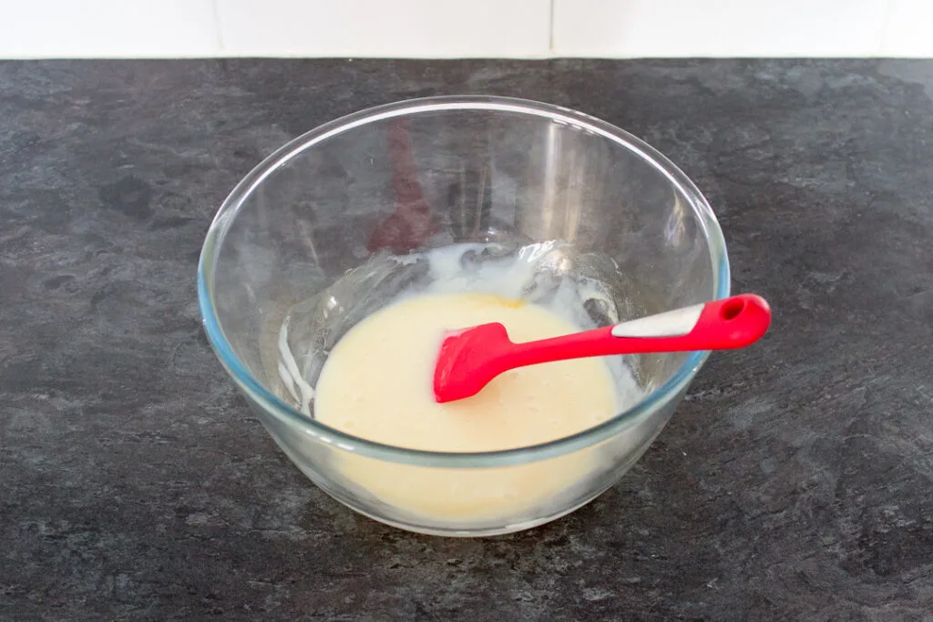 Condensed milk and vanilla mixed together in a bowl