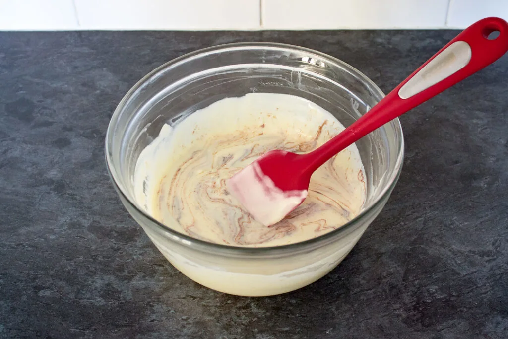 No churn Nutella ice cream being mixed together with a spatula