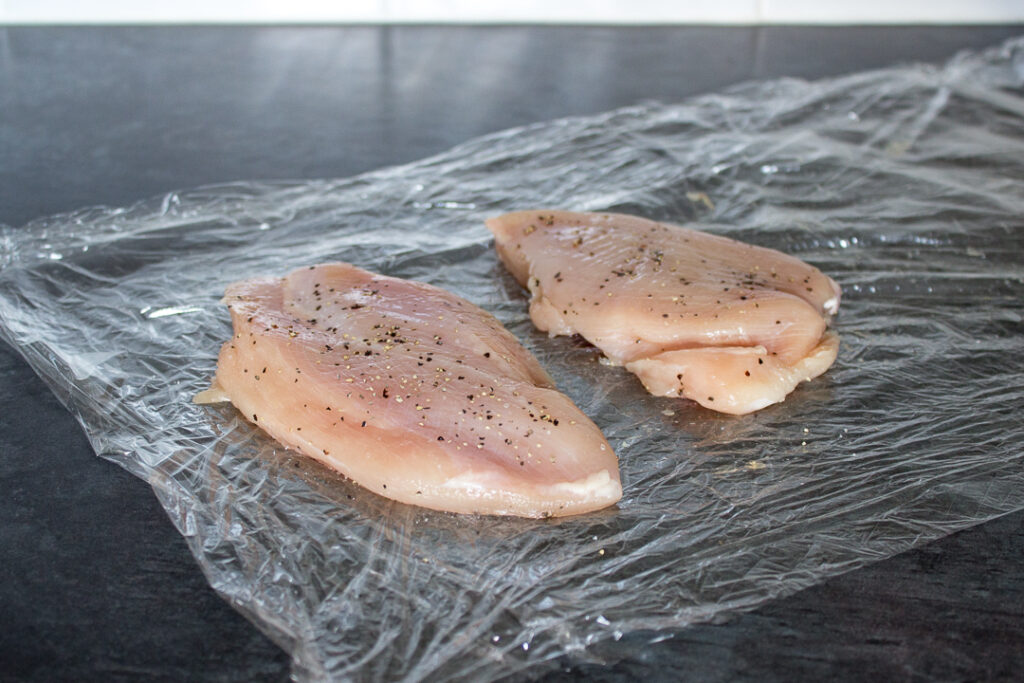Flattened chicken breasts seasoned with salt and pepper