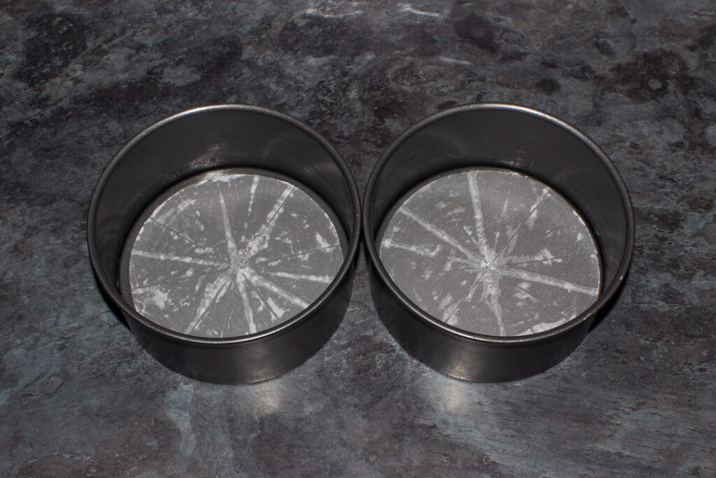Two lined round cake tins
