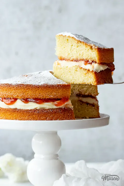 Close up of a slice of air fryer sponge cake being held up