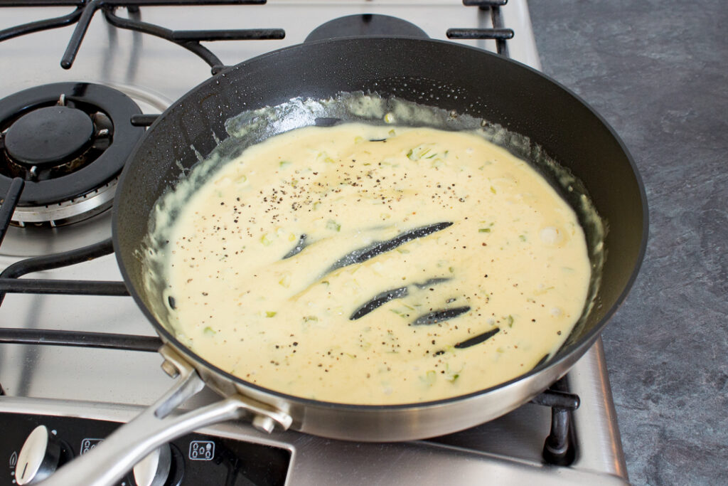 Creamy honey mustard chicken sauce in a frying pan