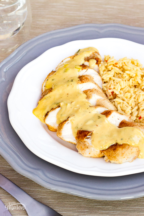 Creamy honey mustard chicken on a white plate with rice