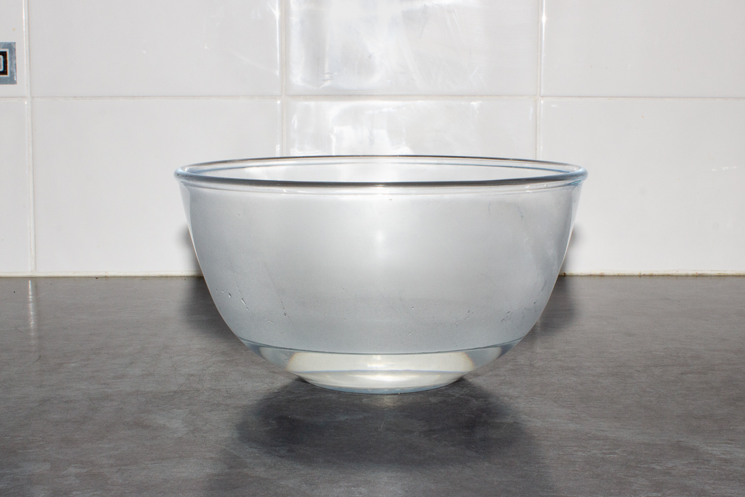 A glass bowl with boiling water in it