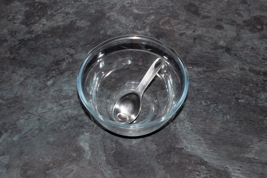 A bowl with 2-3 tbsp water in it