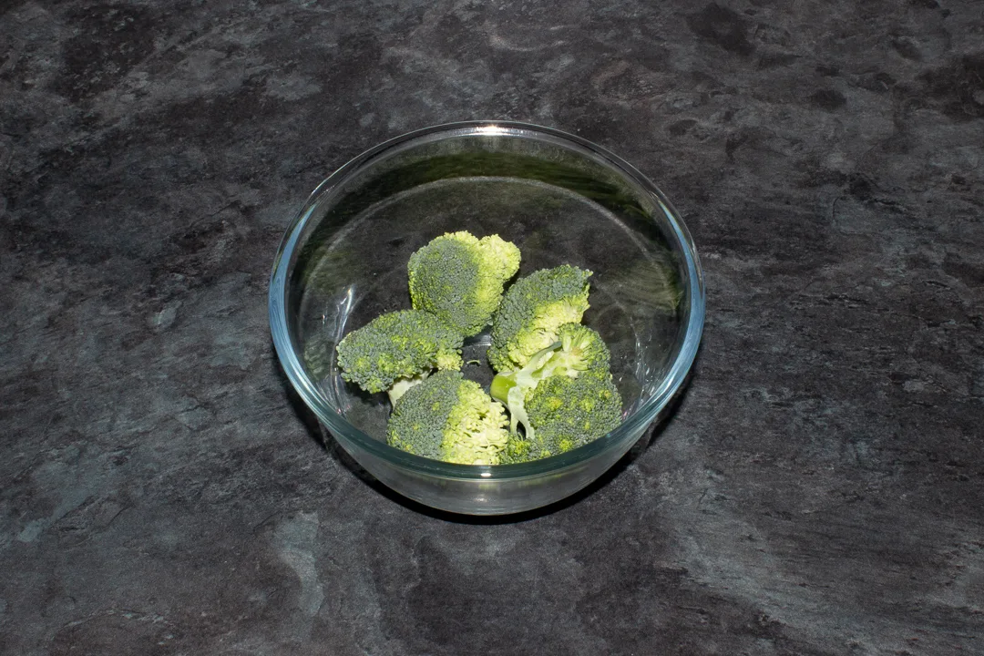 Raw broccoli in a bowl with a little water
