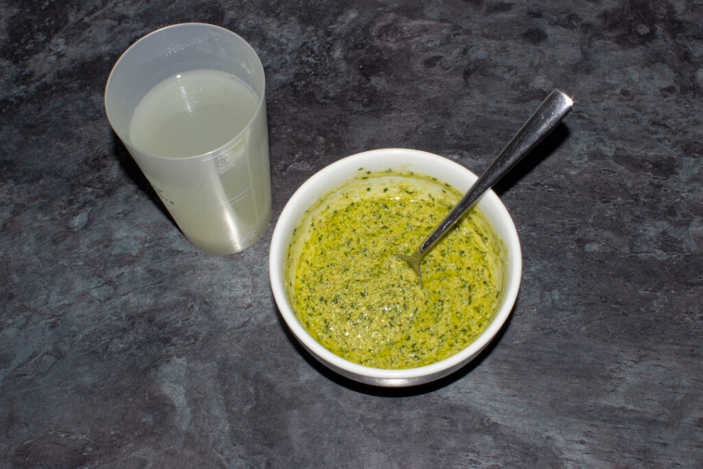 Homemade pesto in a bowl with added pasta water mixed in