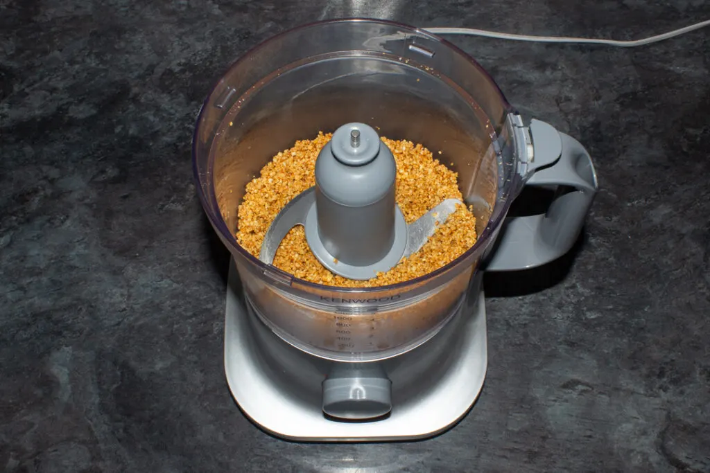 Finely chopped pine nuts and garlic in a food processor