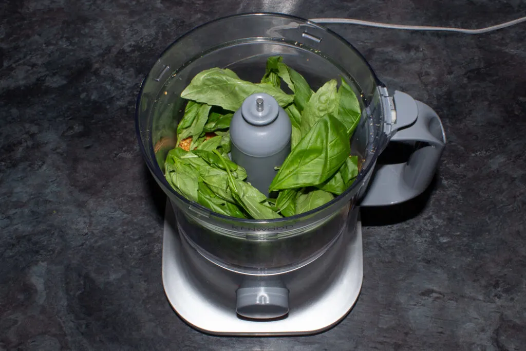 Pine nuts, garlic and basil leaves in a food processor