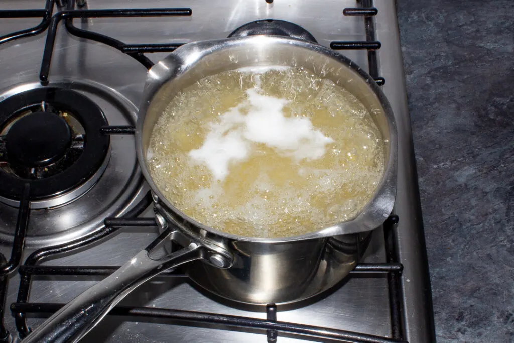 Pasta cooking in a pan of boiling water