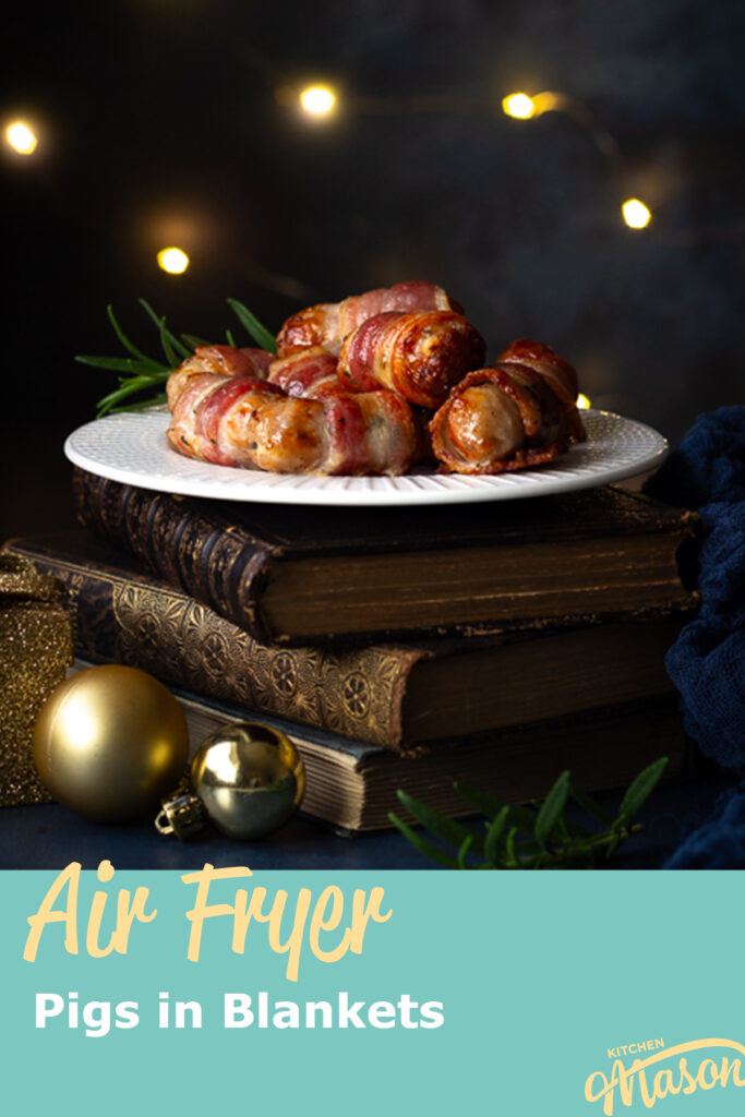 A plate of air fryer pigs in blankets on a stack of books